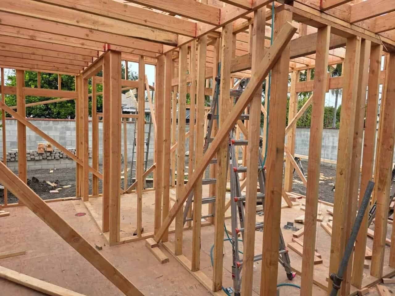 Interior view of a home addition framing in Culver City — wall studs, top plates, and diagonal shear bracing under construction