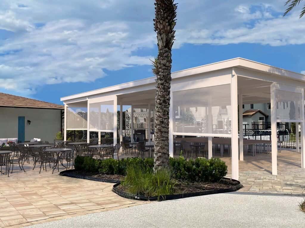 White IntelliShade pergola enclosed with privacy walls and screens